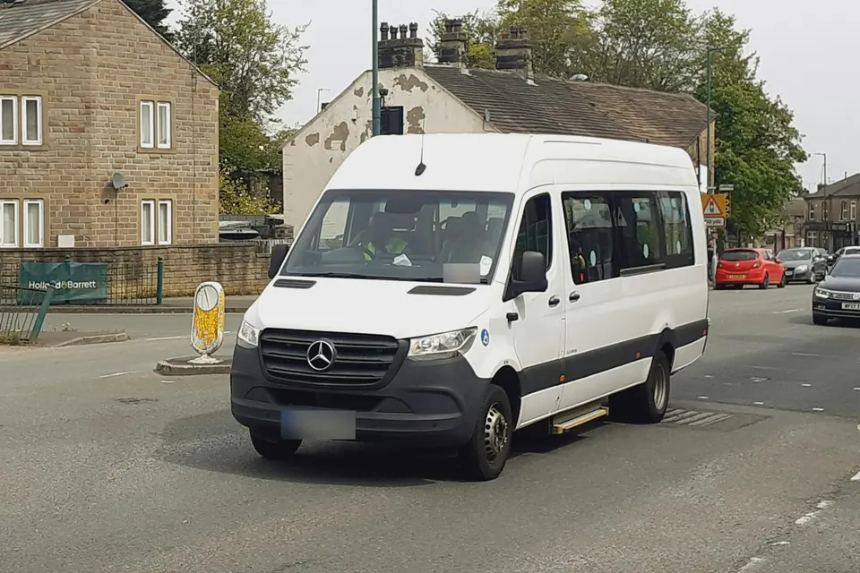 White 14-seater minibus for group hire in Ghana