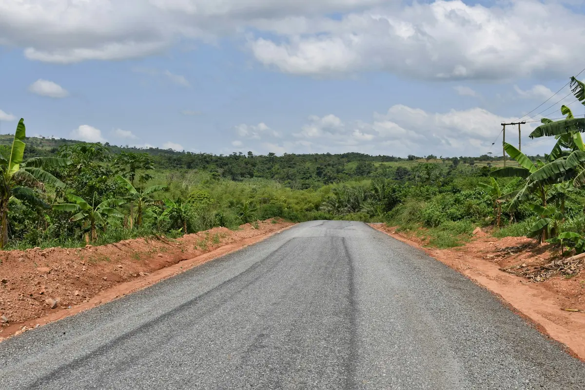 Open road through green countryside in Ghana