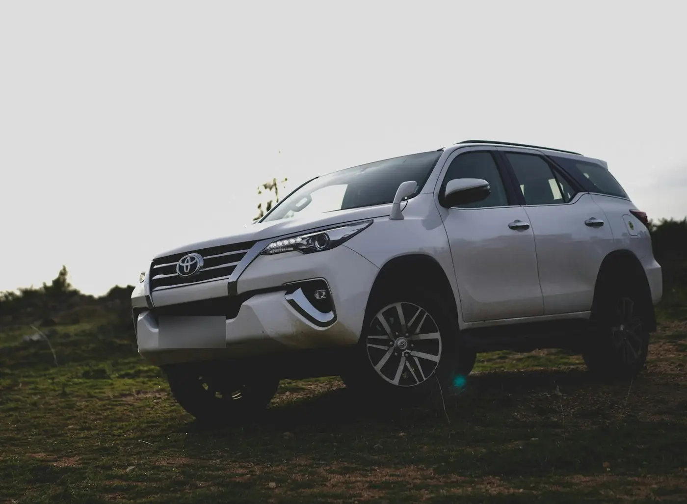 Silver Toyota Fortuner 4x4 parked on grass